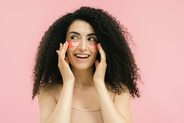 a woman with a lot of makeup on her face, trending on pexels, happening, symmetrical face happy, pink arches, hand on cheek, manuka