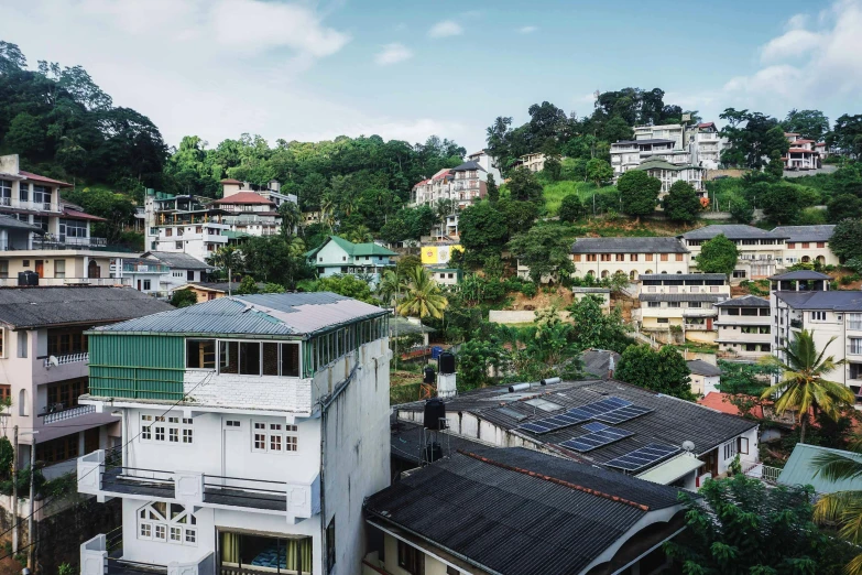 a group of buildings sitting on top of a lush green hillside, hurufiyya, rooftop, sri lanka, street view, flat lay