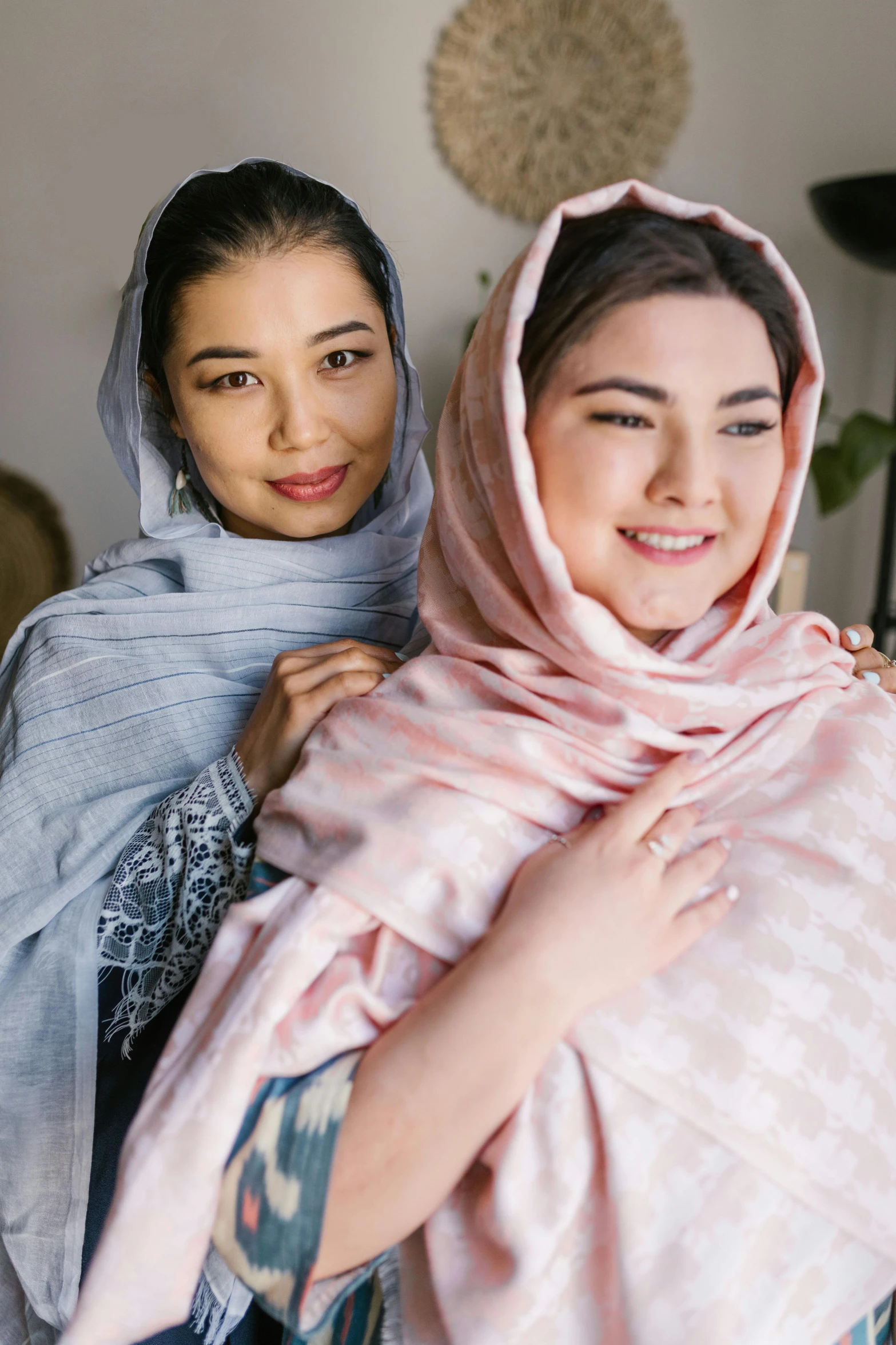 a couple of women standing next to each other, inspired by Maryam Hashemi, featured on instagram, hurufiyya, covered with blanket, asian descent, blush, product shot