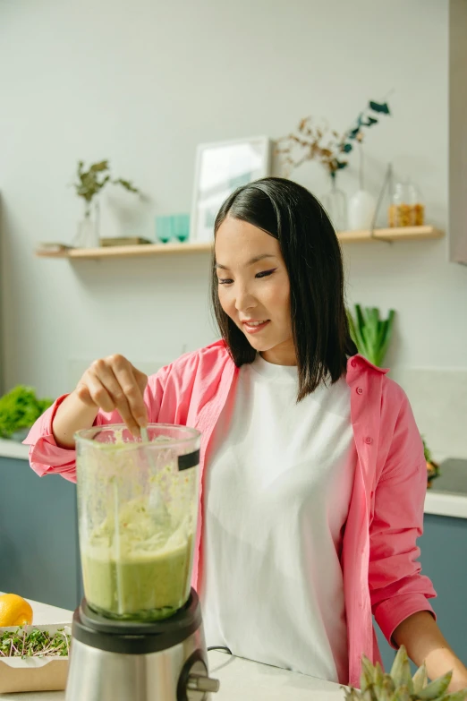 a woman is making a green smoothie in a blender, pexels contest winner, renaissance, young asian woman, avatar image, hydration, 4l