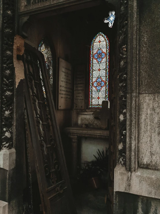 a doorway leading to a stained glass window, a photo, unsplash contest winner, gothic art, london cemetery, standing over a tomb stone, belongings strewn about, tiny ornate windows