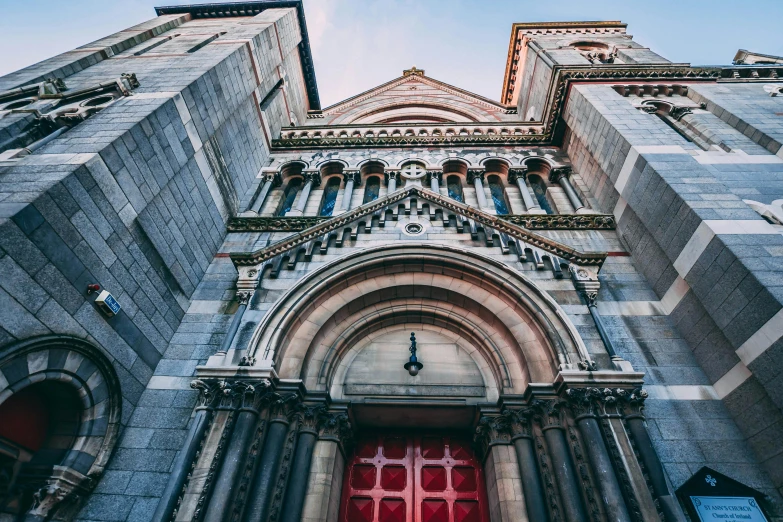 a tall building with a red door in front of it, pexels contest winner, romanesque, chrome cathedrals, looking upwards, 🚿🗝📝