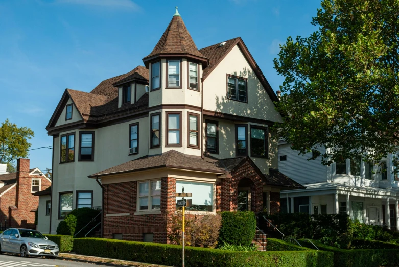 a house with a car parked in front of it, by Washington Allston, art nouveau, turrets, dramatic warm morning light, lush brooklyn urban landscaping, profile image