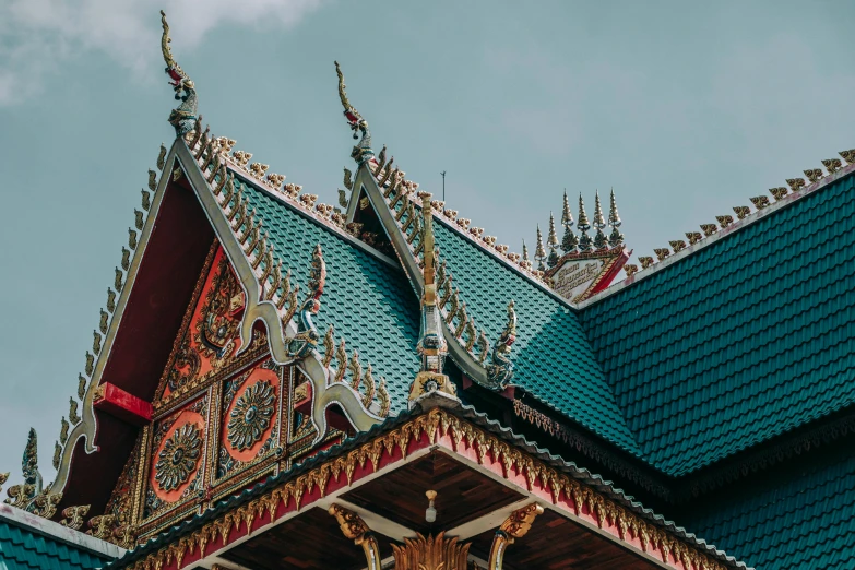 the roof of a building with a clock on it, pexels contest winner, cloisonnism, thai temple, olive green and venetian red, teal aesthetic, asymmetrical spires