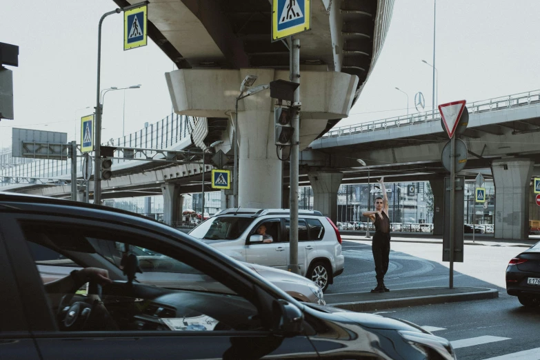 a couple of cars that are sitting in the street, pexels contest winner, moscow metro, overpass, man standing, traffic signs