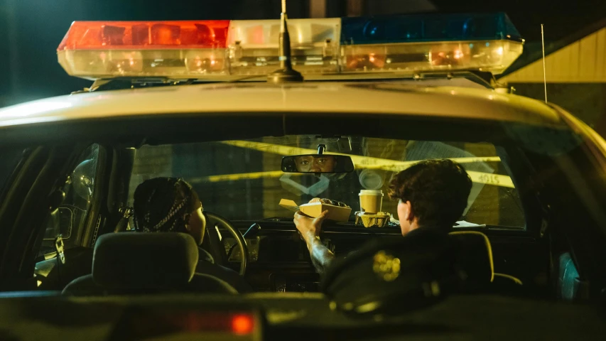 a couple of people that are sitting in a car, by Carey Morris, pexels contest winner, police scene, diner scene, police tape, underlit