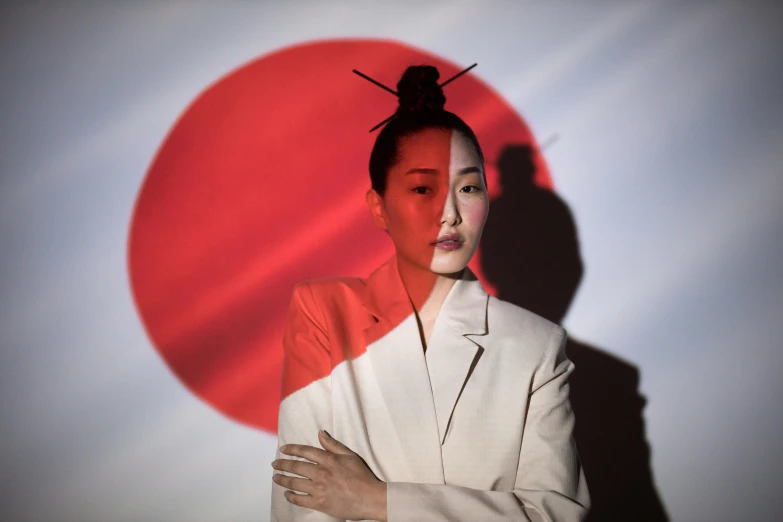 a woman standing in front of a red and white background, an album cover, inspired by Shinoda Toko, geisha make up, ap