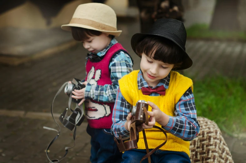 a couple of young boys standing next to each other, pexels, visual art, tipping his fedora, playing games, wearing farm clothes, with nikon cameras