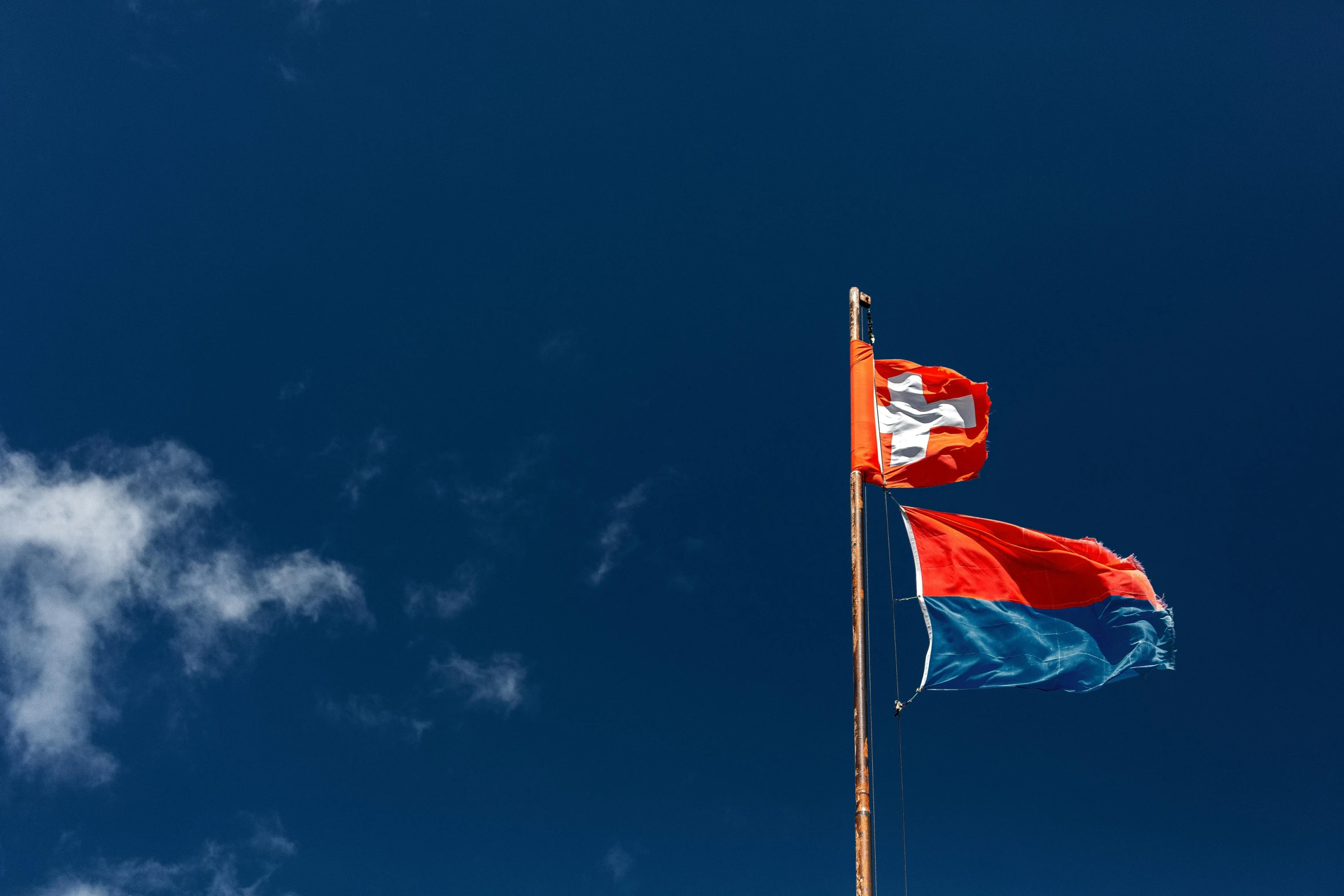 a couple of flags that are flying in the air, by Niko Henrichon, unsplash, hurufiyya, laos, red blue, square, high quality upload