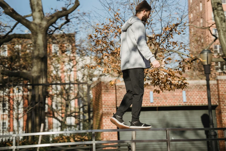 a man riding a skateboard down the side of a metal rail, by Niko Henrichon, unsplash, happening, autumnal, standing on top of a piano, 15081959 21121991 01012000 4k, male calisthenics