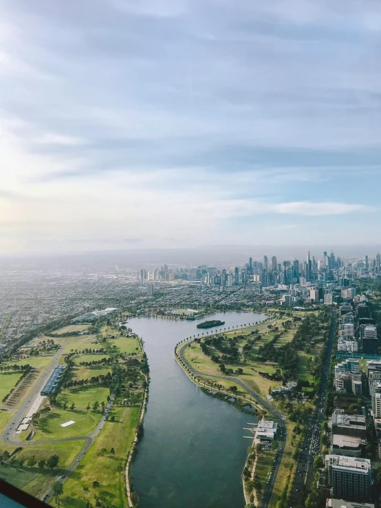 a view of a city from an airplane, by Anna Findlay, pexels contest winner, melbourne, parks and lakes, background image, panorama view of the sky