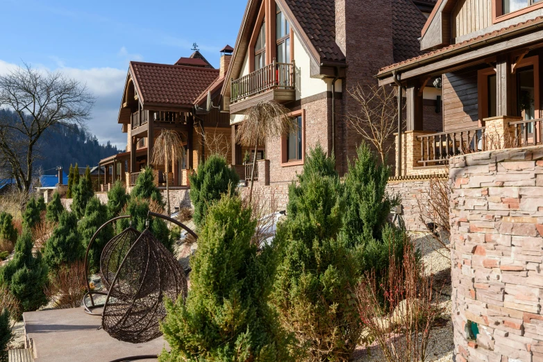 a row of houses next to a body of water, a portrait, by Aleksander Gierymski, shutterstock, art nouveau, log houses built on hills, red sandstone natural sculptures, 000 — википедия, pine