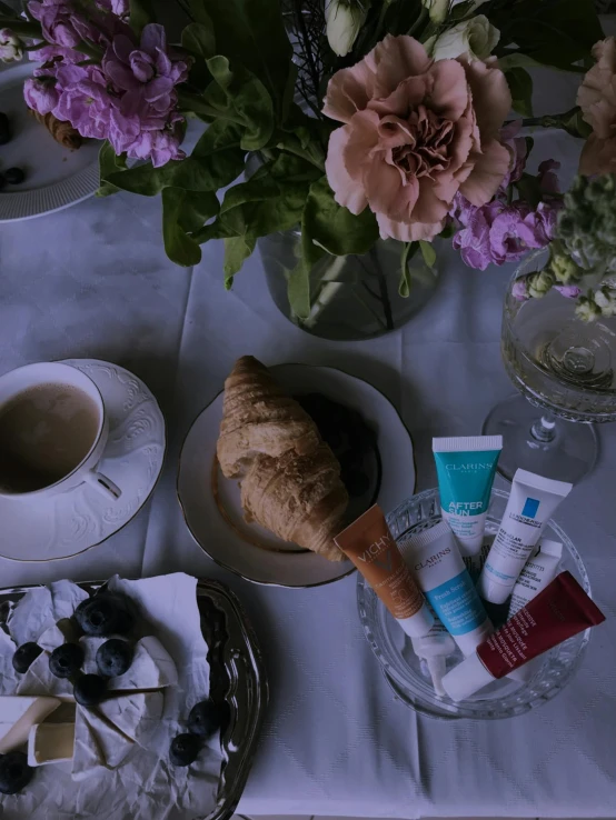 a table topped with plates of food and cups of coffee, a still life, inspired by Alexander Roslin, unsplash, photoshoot for skincare brand, french impressionism, ((oversaturated)), blue