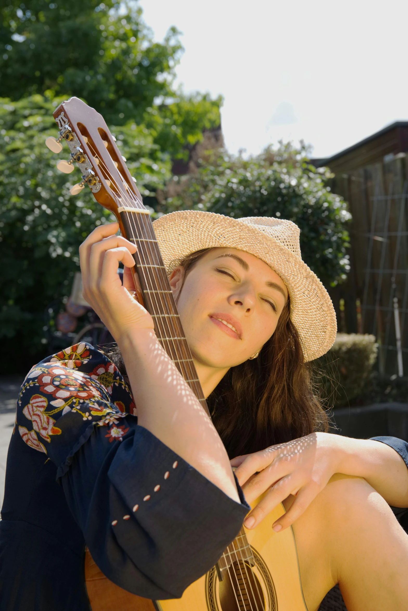 a woman sitting on the ground with a guitar, profile image, wearing sombrero, charli bowater, portrait image