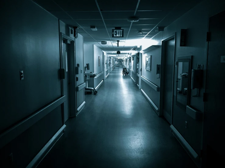 a black and white photo of a hospital hallway, an album cover, pexels contest winner, dark night environment, brightly lit blue room, horror environment, istock