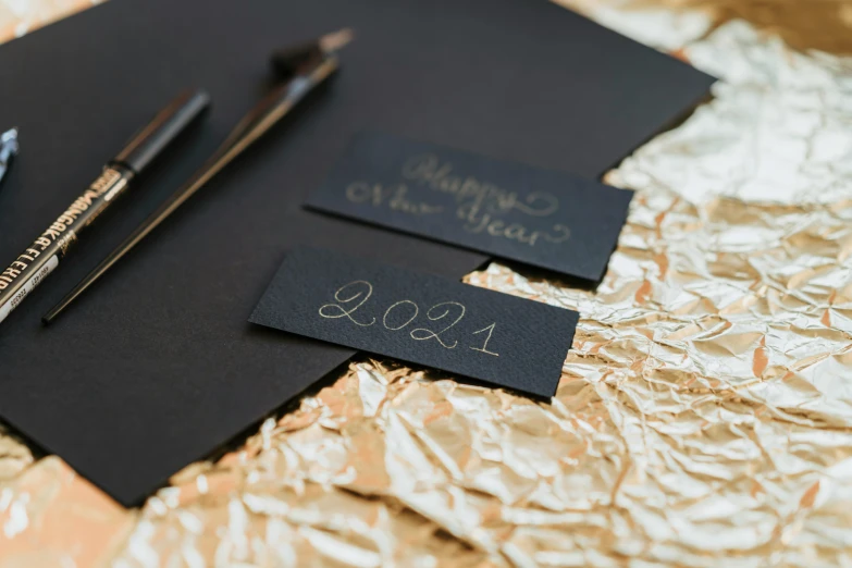 a pair of scissors sitting on top of a piece of paper, by Julia Pishtar, private press, new years eve, gilding, thumbnail, all black matte product