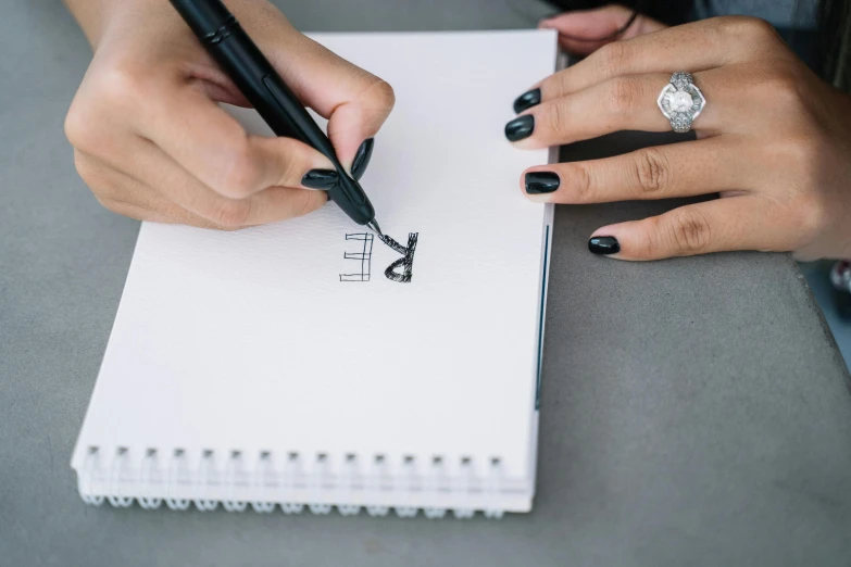 a person writing on a notebook with a pen, a drawing, by Mathias Kollros, pexels contest winner, two people, uppercase letter, very minimalistic, thumbnail