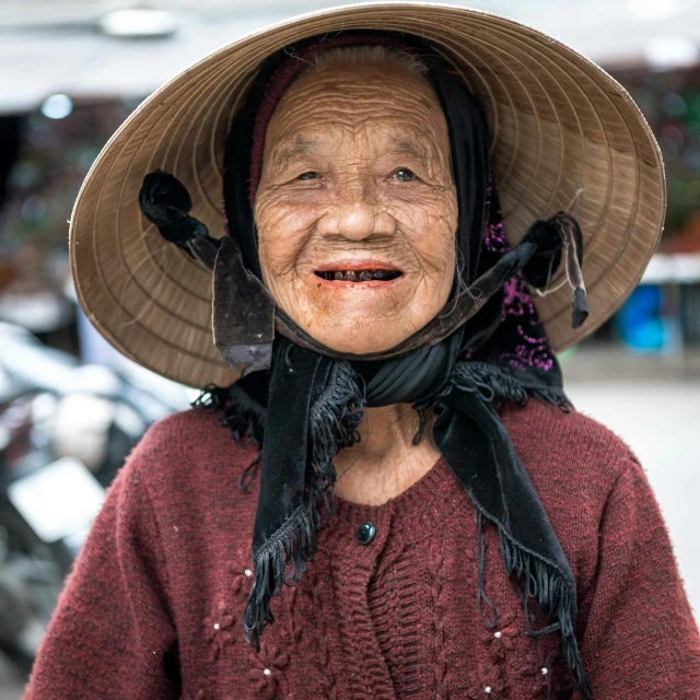 a close up of a person wearing a hat, a portrait, pexels contest winner, cloisonnism, old lady cyborg merchant, smiling for the camera, mai anh tran, covered head