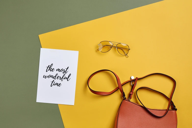 a pair of glasses and a handbag on a yellow and green background, trending on pexels, postminimalism, wonderous, style lettering, still life photo of a backdrop, full of wonderful things