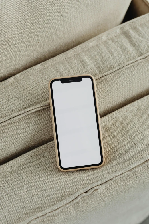 a close up of a cell phone on a couch, trending on pexels, sandy beige, made of bamboo, ios icon, blank