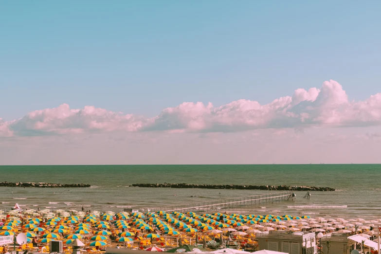 a beach filled with lots of umbrellas next to the ocean, a colorized photo, unsplash contest winner, renaissance, moody : : wes anderson, panorama view of the sky, happy italian beach scene, dunkirk