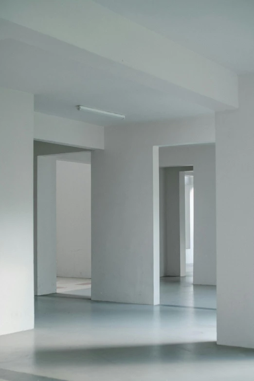 an empty room with white walls and floors, inspired by Cerith Wyn Evans, corridor, backrooms office space, steffen sauerteig, white wall coloured workshop