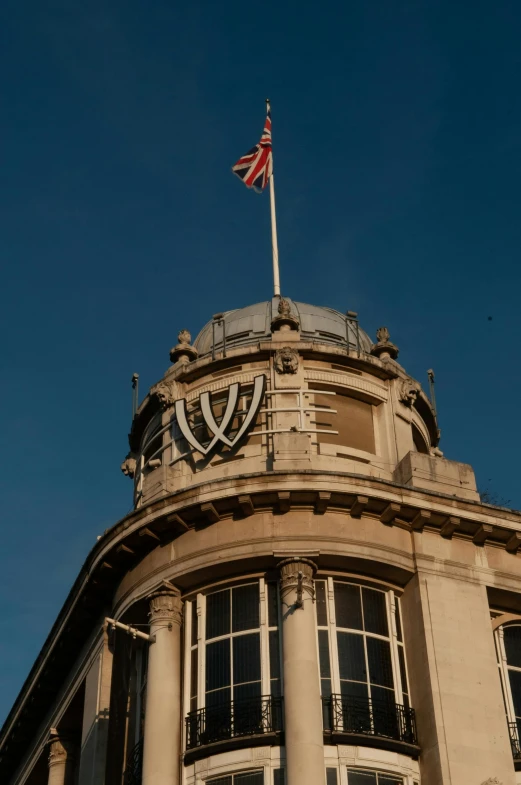 a building with a flag on top of it, inspired by Edwin Deakin, renaissance, halo above head, shot from roofline, piltover, palace