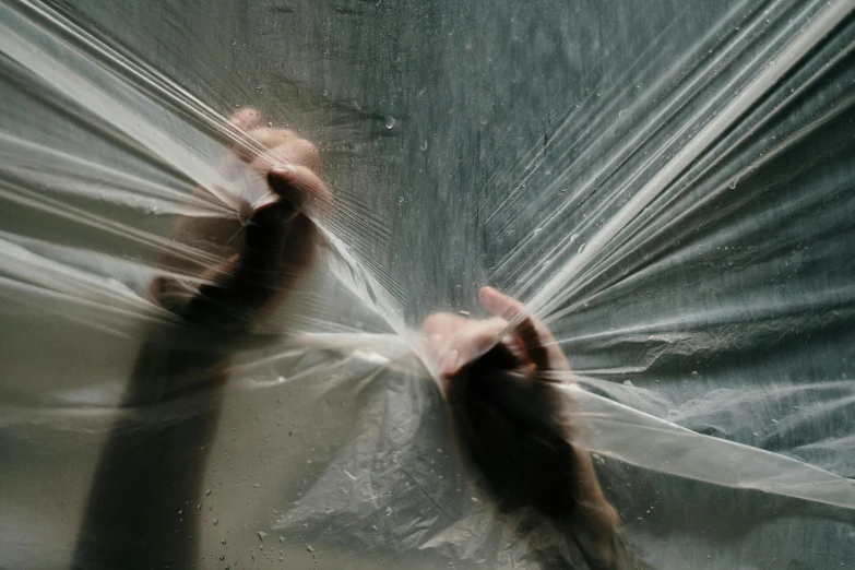 a close up of a person holding a plastic bag, inspired by Cornelia Parker, pexels contest winner, ethereal curtain, showers, artem chebokha, playing