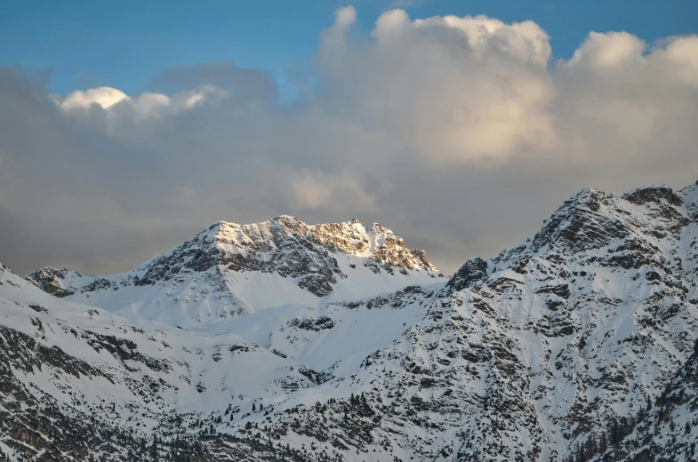 a group of people riding skis on top of a snow covered mountain