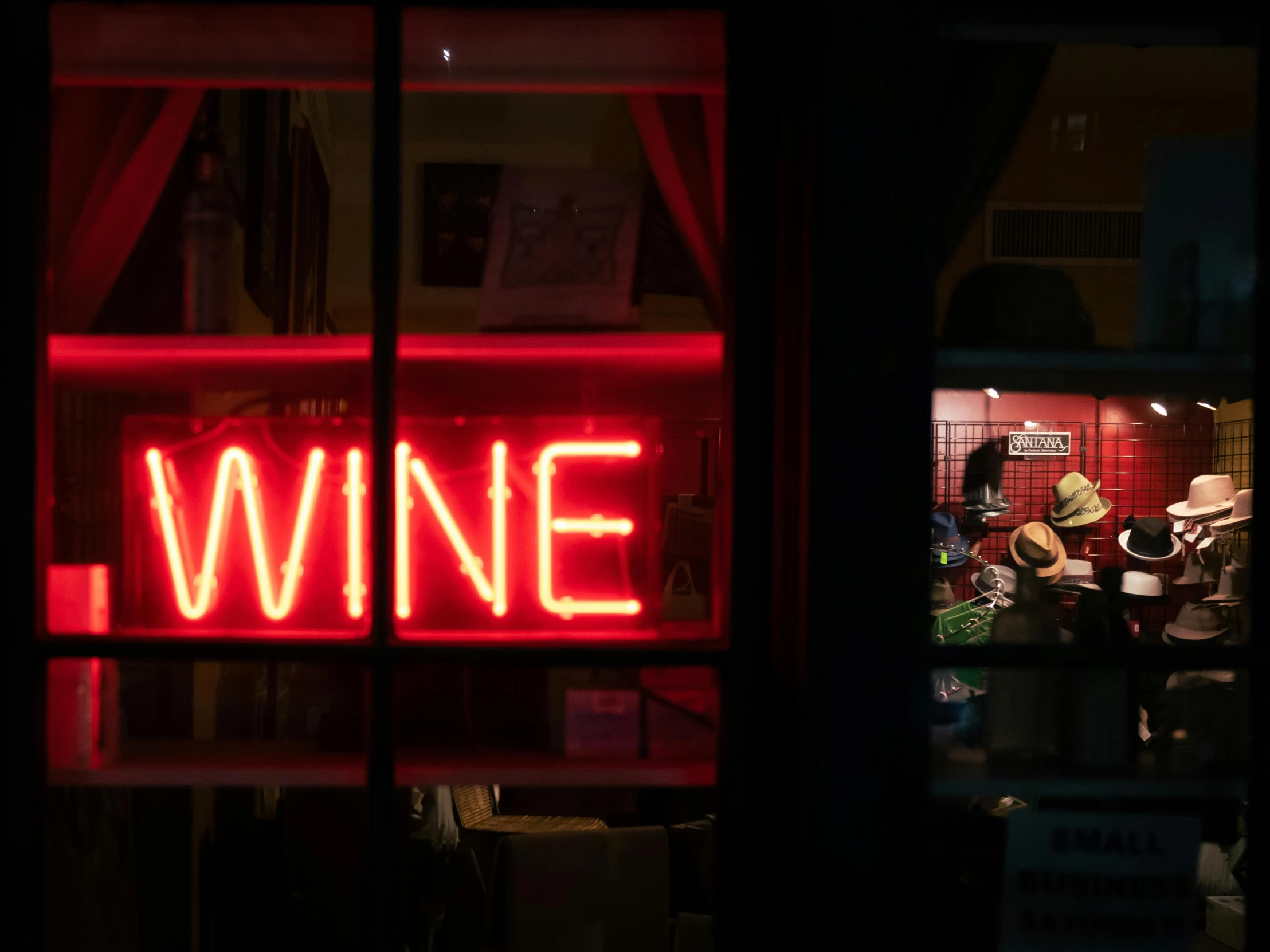 a neon sign that says wine in front of a window, pexels contest winner, australian tonalism, exiting store, red wine, niel davis, again and again