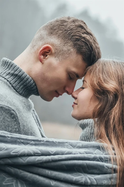 a man and a woman wrapped in a blanket, a picture, trending on pexels, peasant boy and girl first kiss, confident looking, grey, touching heads