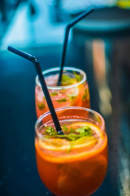 a couple of drinks sitting on top of a table, straw, zoomed in, daily specials, infused