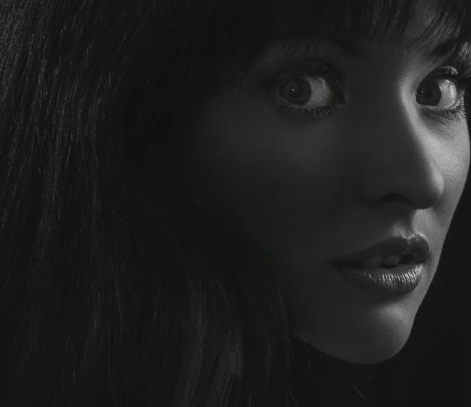 a black and white photo of a woman's face, inspired by Ayami Kojima, black bangs, olivia pope, sneering. cinematic lighting, ad image