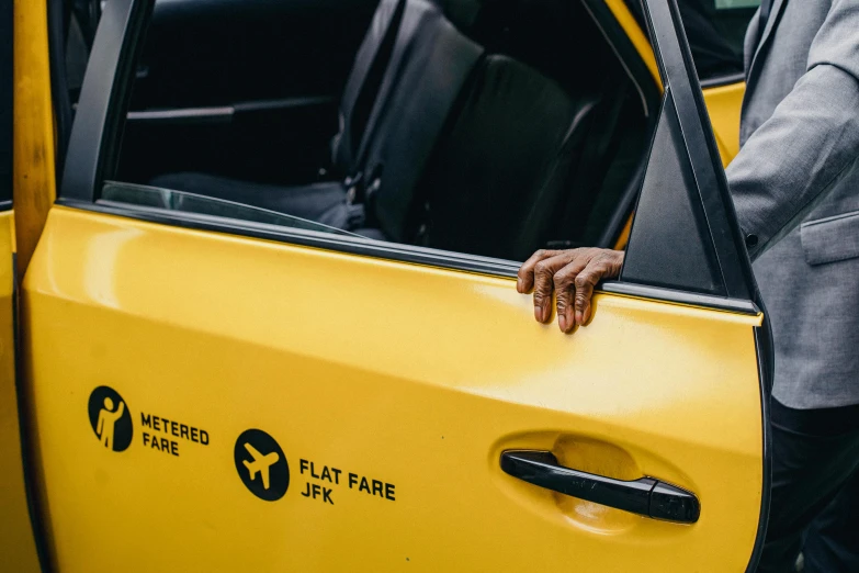 a man in a suit getting out of a taxi, by Matija Jama, pexels contest winner, hyperrealism, yellow and black color scheme, jean - michel basquiat, tail fin, resting