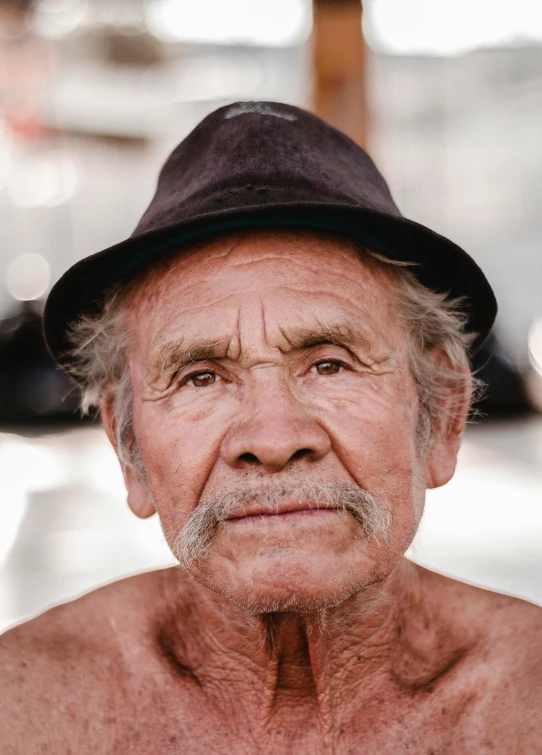 a close up of a person wearing a hat, a colorized photo, by Jan Tengnagel, pexels contest winner, photorealism, portrait photo of an old man, square masculine facial features, chilean, asian male