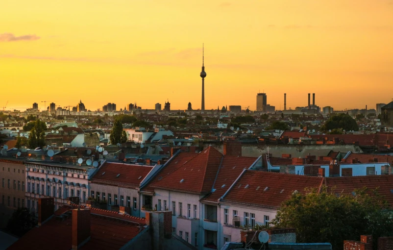 a view of a city from the top of a building, pexels contest winner, berlin secession, pastel orange sunset, a quaint, a colorful, panoramic