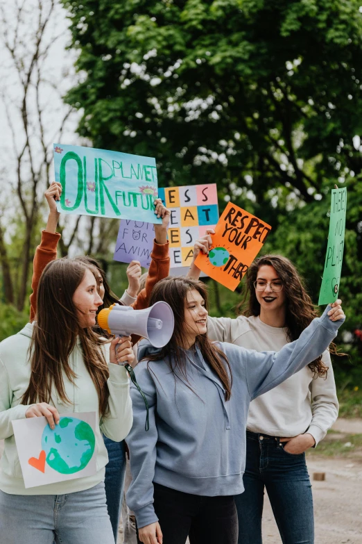 a group of women standing next to each other holding signs, by Anna Katharina Block, trending on pexels, renaissance, green gas spreading across land, teenager girl, 🚿🗝📝