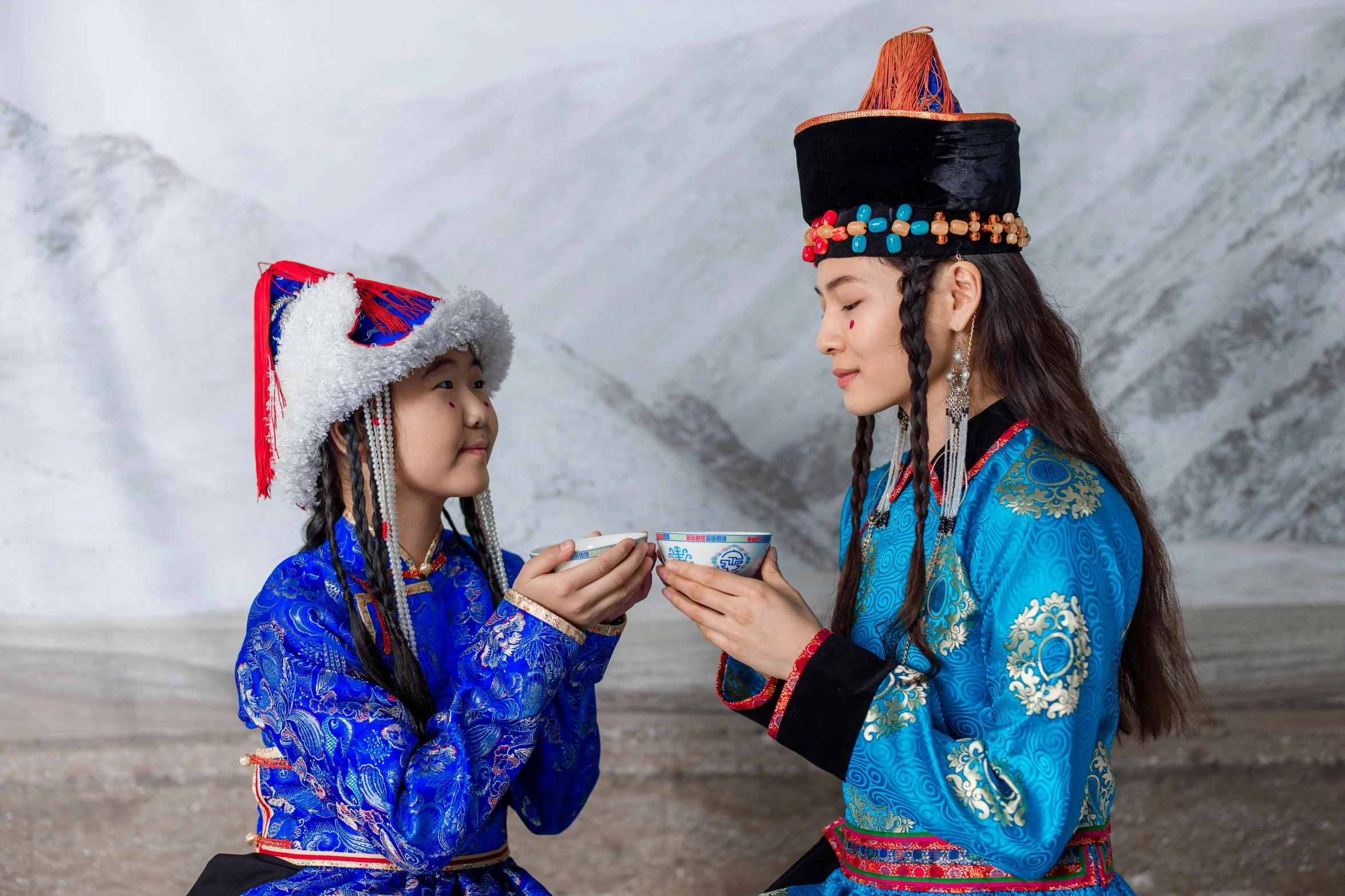 a couple of women sitting next to each other, pexels contest winner, cloisonnism, wearing festive clothing, avatar image, mongol, freezing