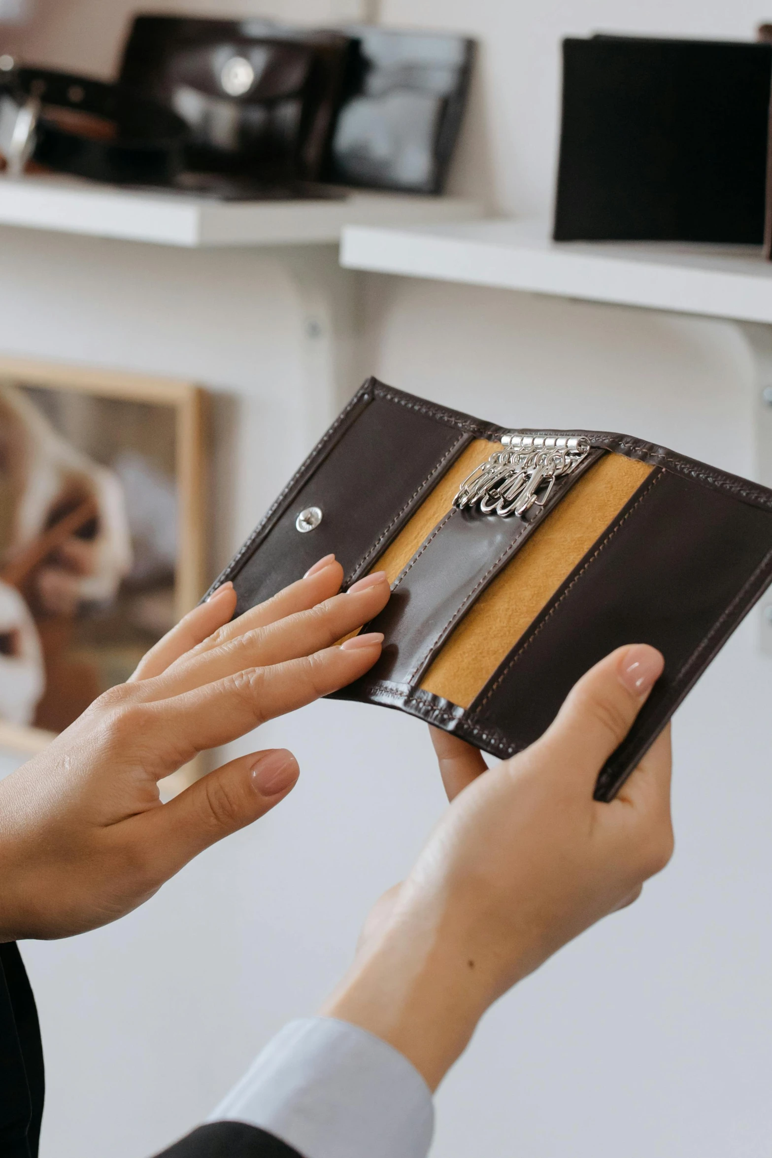 a close up of a person holding a wallet, private press, product display, with small object details, thumbnail, small in size