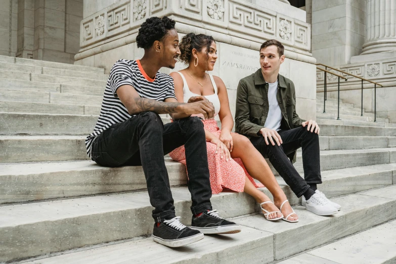 a group of people sitting on the steps of a building, profile image, alexis franklin, playful vibe, thoughtful pose