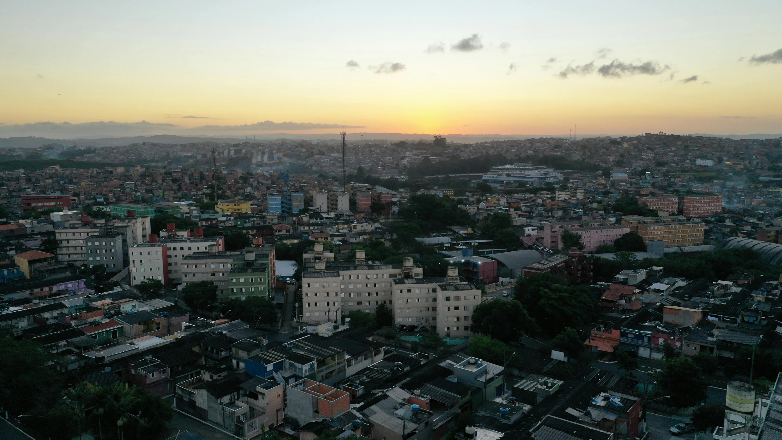 an aerial view of a city at sunset, hurufiyya, caio santos, view from the side