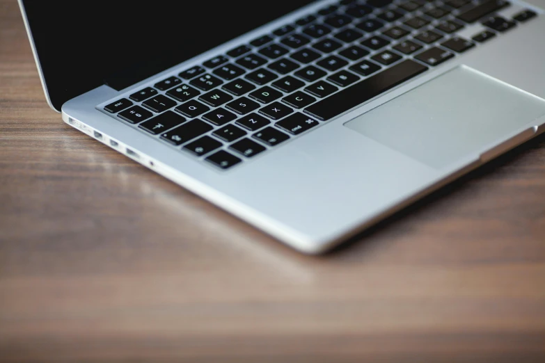 a laptop computer sitting on top of a wooden table, by Carey Morris, pexels, bottom angle, crisp detail, glossy surface, 15081959 21121991 01012000 4k