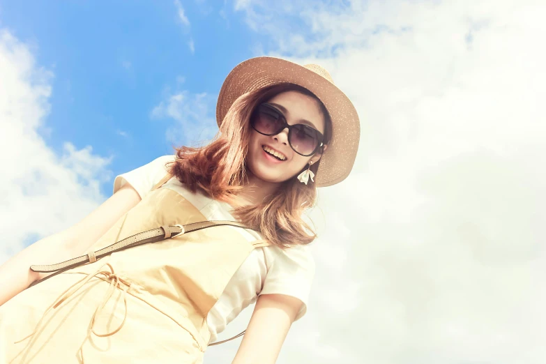 a woman in a hat and dress holding a suitcase, trending on pexels, clear blue skies, girl wearing round glasses, avatar image, pastel clothing