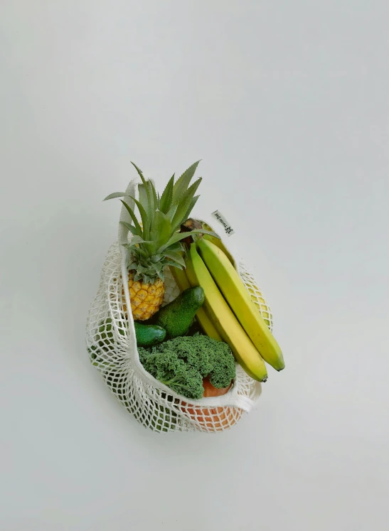 a mesh bag filled with fruit and vegetables, unsplash, net art, facing right, with a soft, tropical, white
