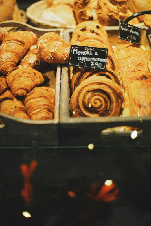 a display case filled with lots of pastries, inspired by Normand Baker, trending on unsplash, warm light, thumbnail, twinkling and spiral nubela, high angle close up shot