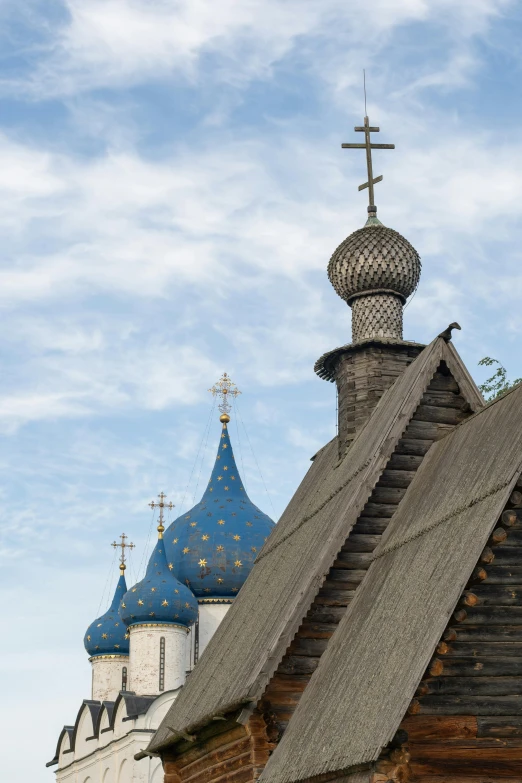 an old wooden church with a blue roof, an album cover, inspired by Károly Markó the Elder, trending on unsplash, cloisonnism, black domes and spires, sergey krasovskiy, morning detail, farms