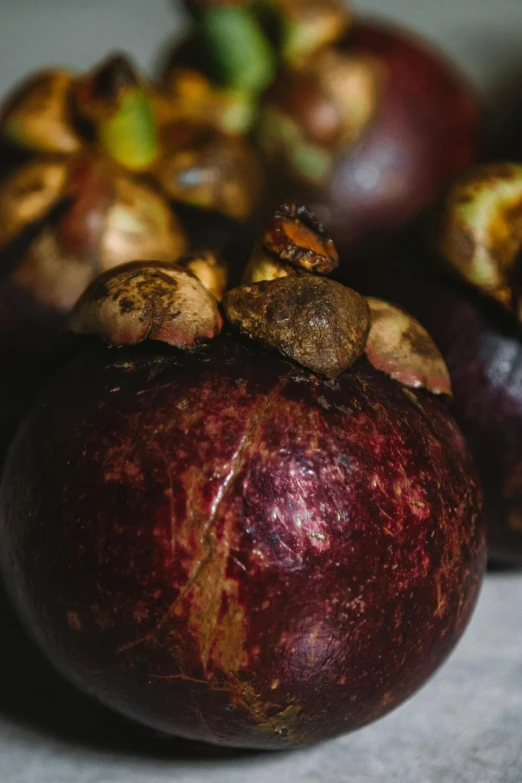 a close up of a bunch of fruit on a table, by Jan Tengnagel, unsplash, process art, mangosteen, madagascar, maroon, multiple stories