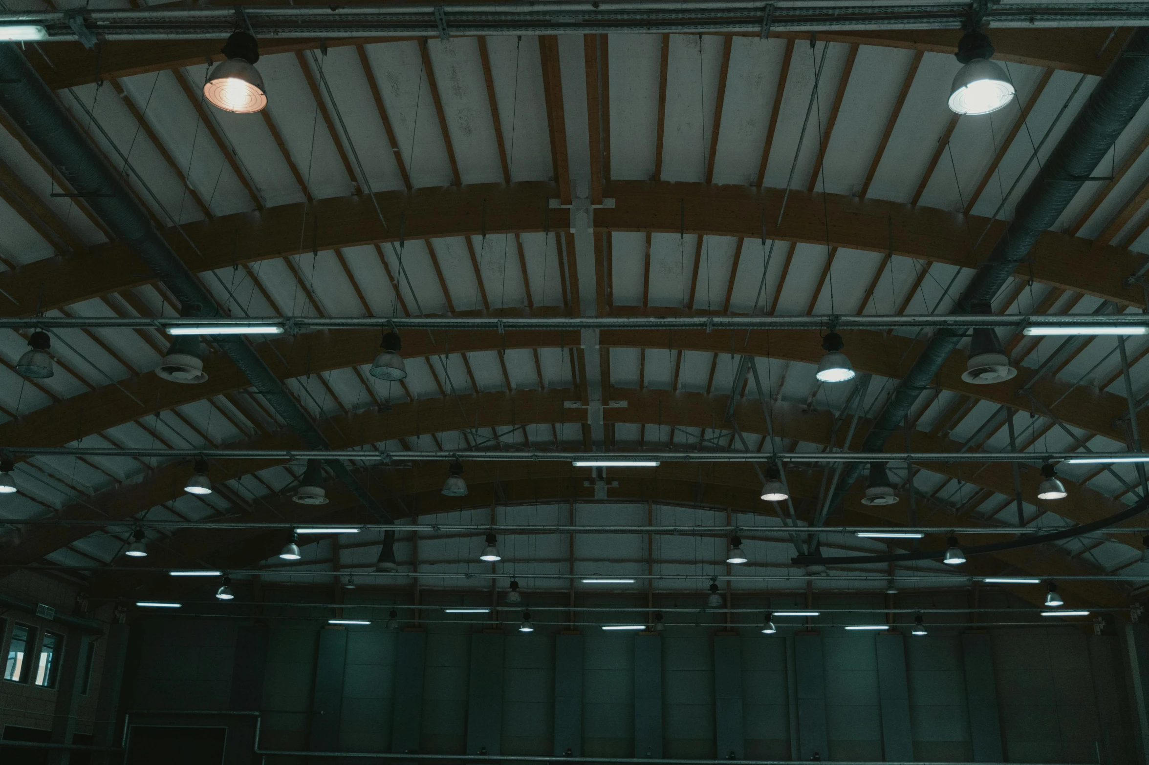 a group of people playing a game of tennis, inspired by Elsa Bleda, light and space, ceiling, low quality photo, warehouse, 8k cinematic lighting