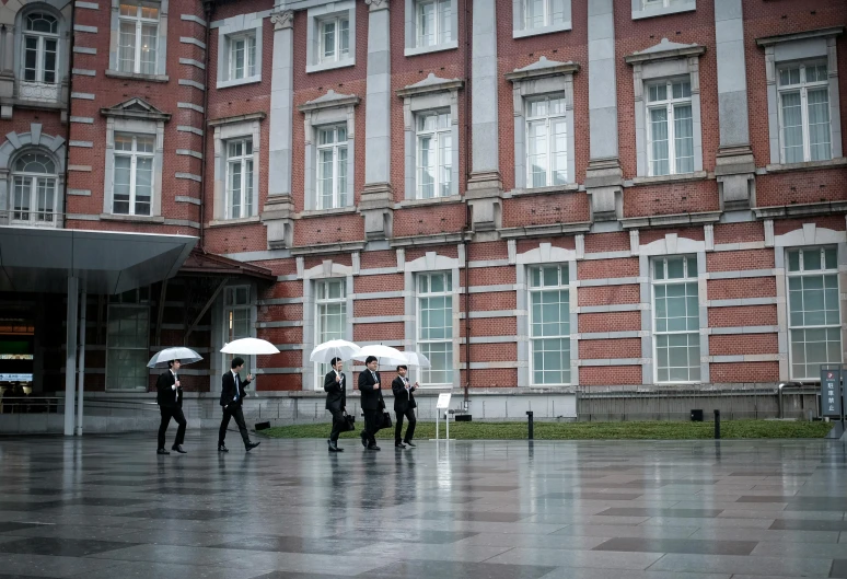 a group of people walking in the rain with umbrellas, a photo, inspired by Tsuji Kakō, unsplash, royal palace, men in tuxedos, square enix, ready for a meeting