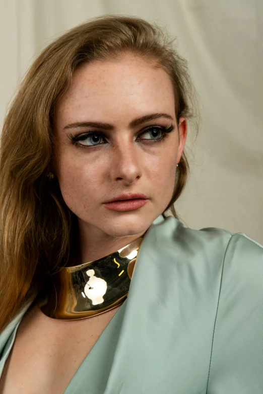 a woman with a collar around her neck, trending on pexels, sophie turner, metallic neoprene woman, portrait n - 9, gold metal